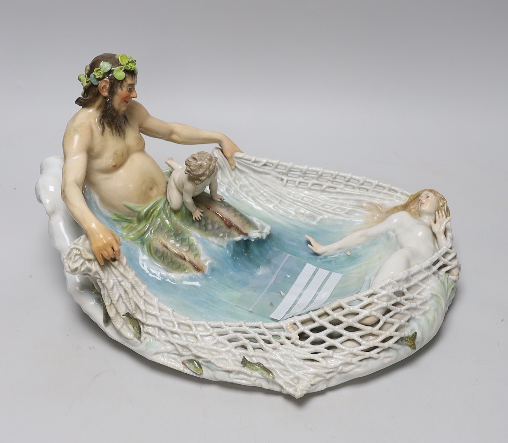 A Meissen group of Triton netting a nymph, early 20th century, modelled by T P Helmig, (a.f.), 38cm long